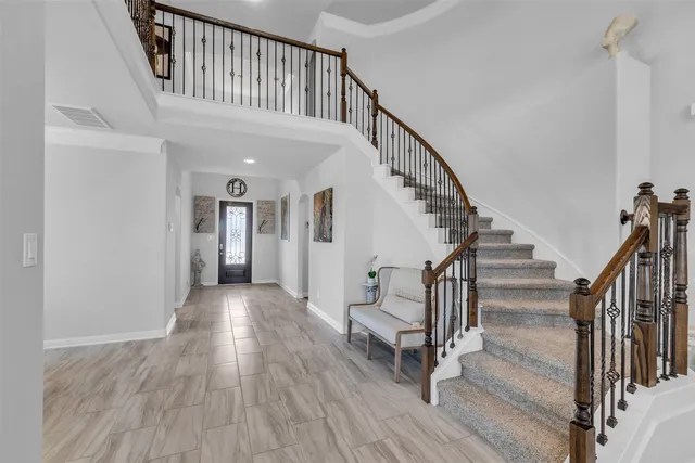 a view of staircase with wooden floor and a chandelier