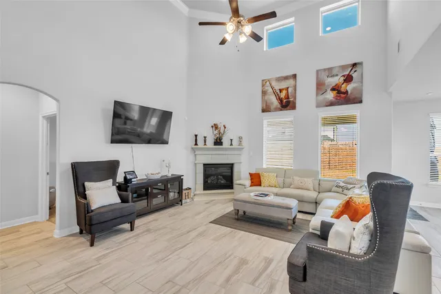 a living room with furniture a fireplace and a flat screen tv