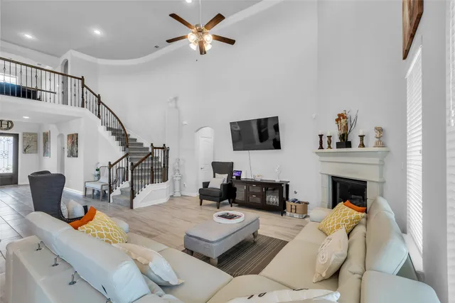 a living room with furniture fireplace and a flat screen tv