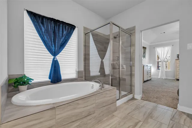 a spacious bathroom with a granite countertop sink and a mirror