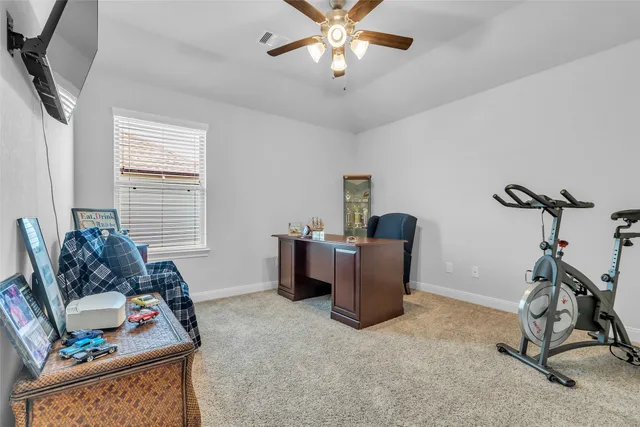 a bedroom with a balcony a bed a dresser and a chandelier