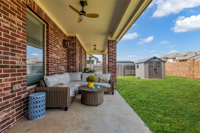 a view of a big house with a big yard and large trees