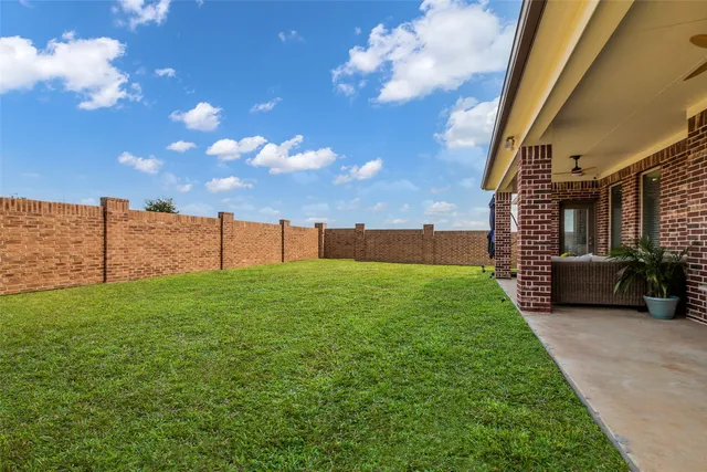 a view of a house with a backyard porch and sitting area