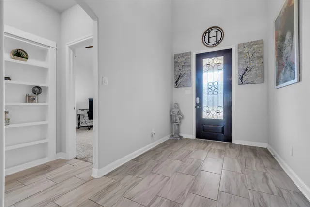 an empty room with mirror and windows