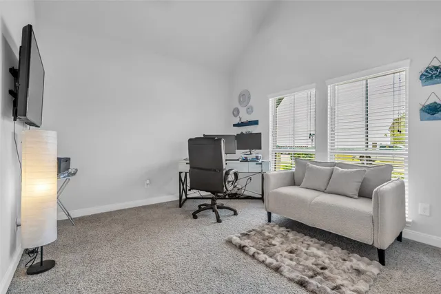 a living room with furniture a rug and a flat screen tv