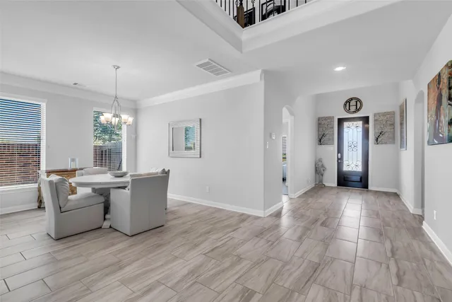a view of a livingroom with furniture wooden floor and windows