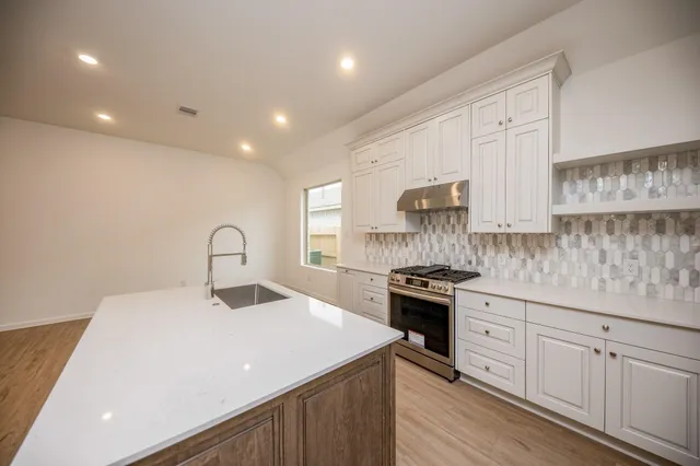 a kitchen with a sink stainless steel appliances and cabinets