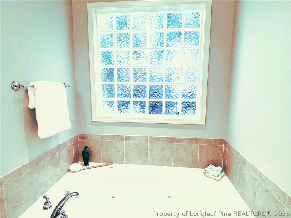 175 Pine Hawk Drive Spring Lake, NC 28390 - Photo 19 of 43 a bath tub sitting in a bathroom next to a window