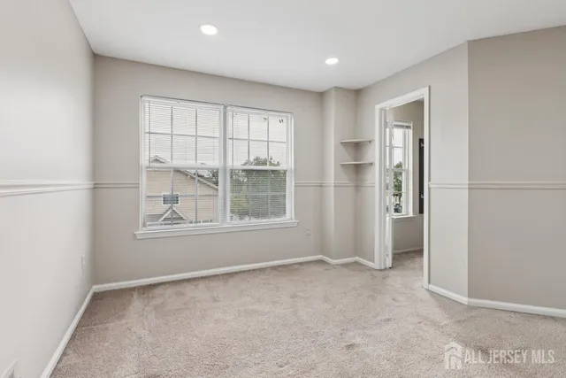 an empty room with windows and closet