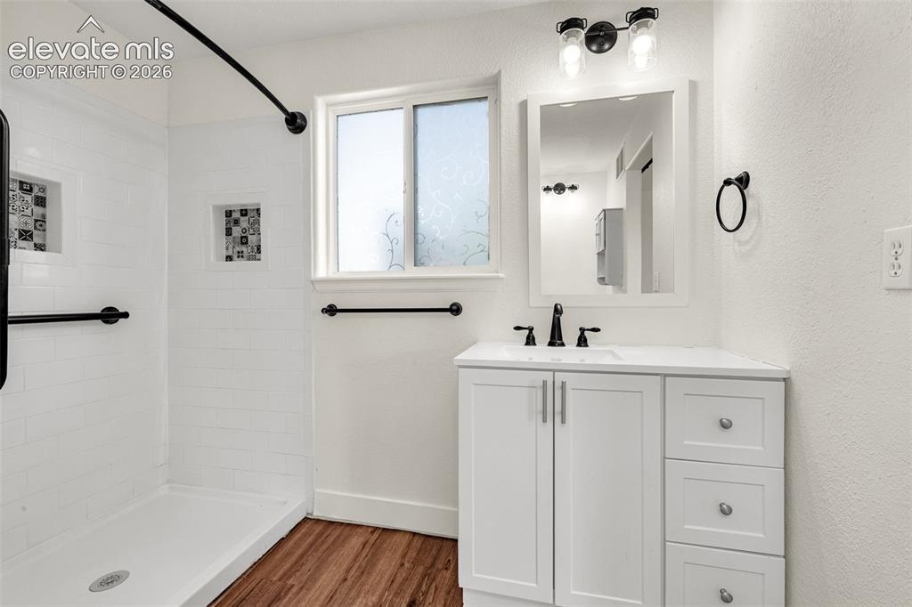 11185 Falling Star Road Fountain, CO 80817 - Photo 25 of 46 a bathroom with a sink a mirror and shower