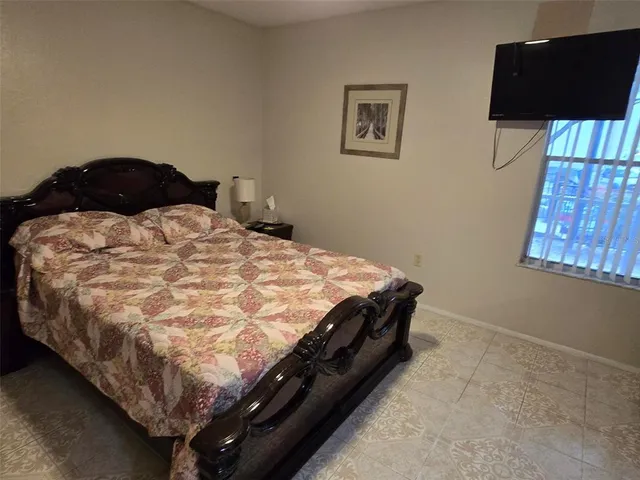 a bedroom with a bed and wall painting