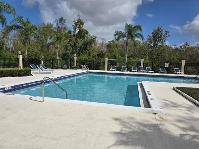 a view of a swimming pool with an outdoor space and seating area