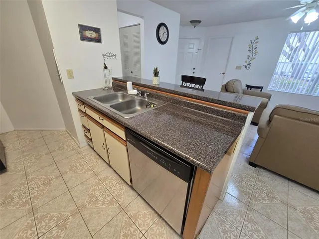 a kitchen with stainless steel appliances granite countertop a sink and a stove
