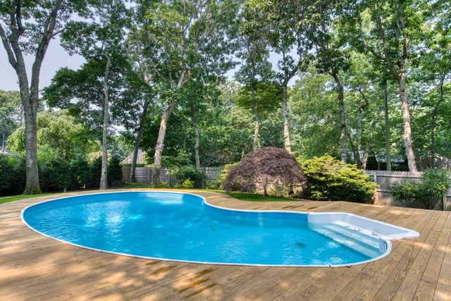 a view of a swimming pool with a yard