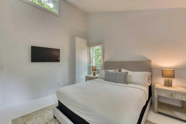 a bedroom with a bed and a flat screen tv