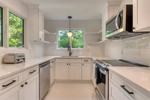 a kitchen with a sink stove and microwave