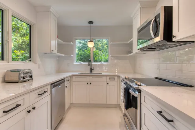 a kitchen with a sink stove and microwave