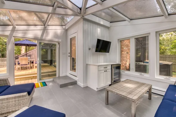 a living room with furniture and a flat screen tv