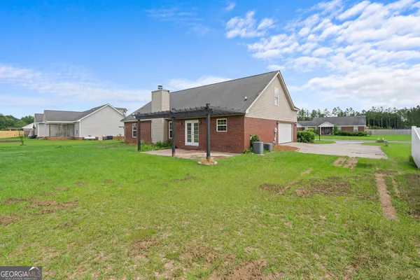 a backyard of a house with table and chairs