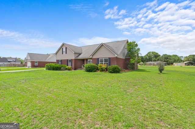 a front view of house with yard and car parked