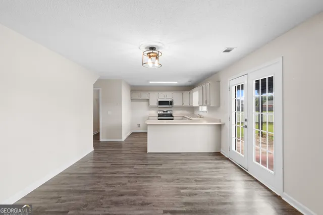 a view of a kitchen with a sink and wooden floor