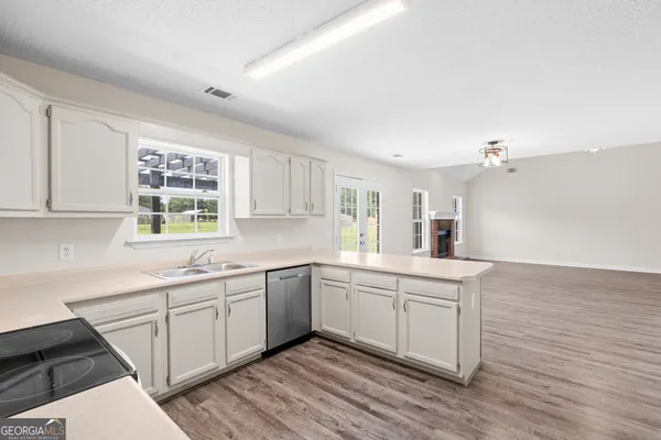 a kitchen with a sink cabinets and window