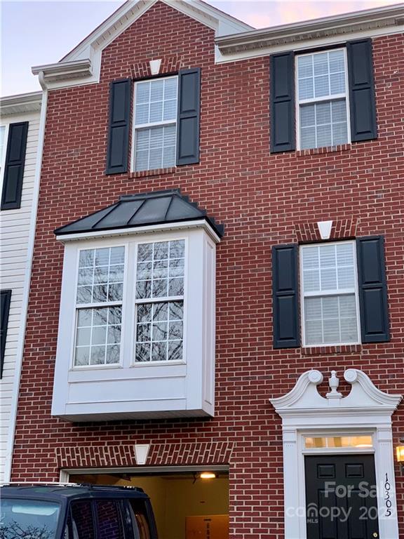 10305 Garrett Grigg Road Charlotte, NC 28262 - Photo 1 of 1 a front view of a house with large windows