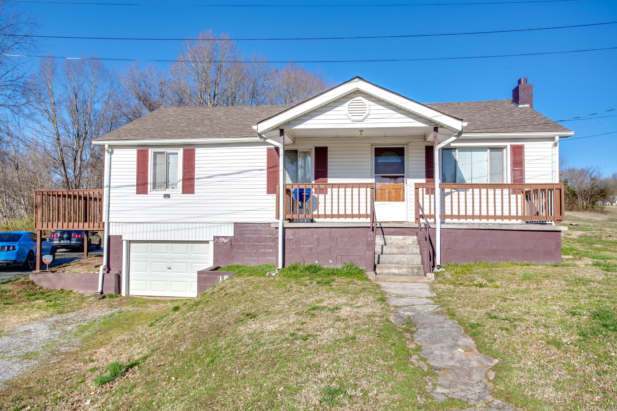 a front view of a house with a garden and deck