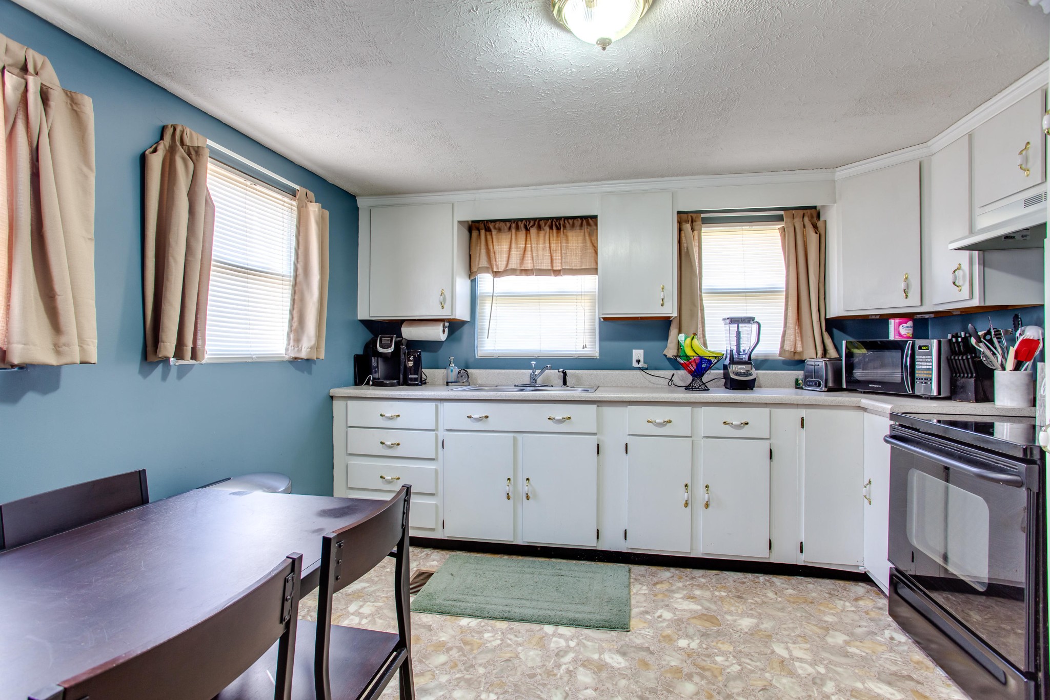 4332 Shipe Road Corryton, TN 37721 - Photo 7 of 25 a kitchen with granite countertop white cabinets window and sink