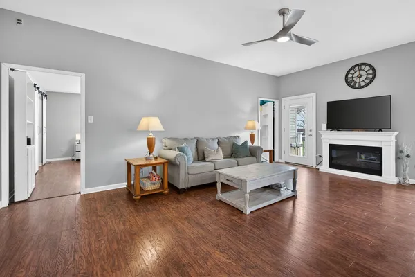 a living room with furniture and a wooden floor