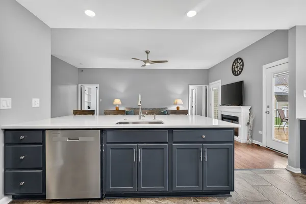 a kitchen with stainless steel appliances a stove sink microwave and cabinets