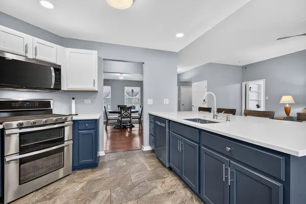 a kitchen with stainless steel appliances granite countertop a refrigerator and a stove