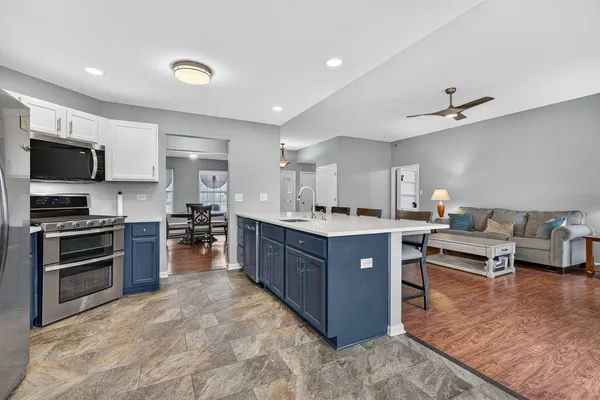a kitchen with stainless steel appliances granite countertop a refrigerator and a stove top oven