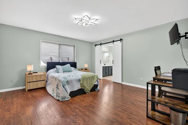 a bedroom with a bed and a table