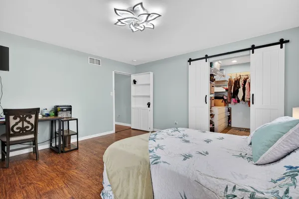 a spacious bathroom with a double vanity sink mirror and toilet