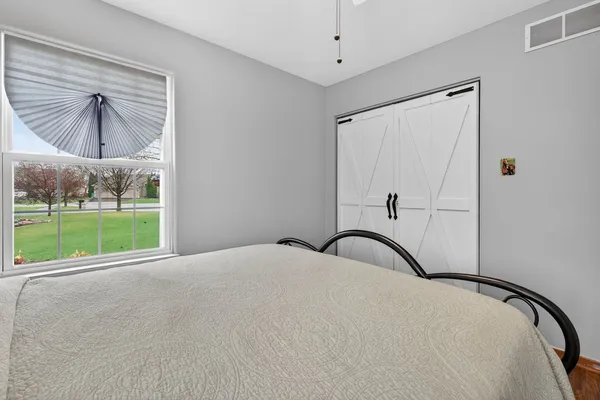 a bedroom with a bed and a mirror