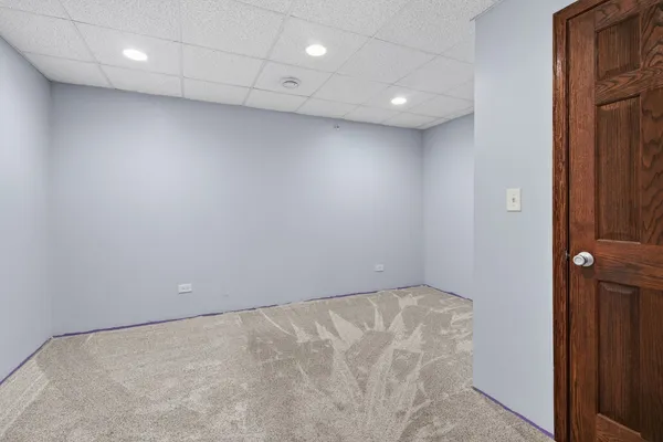 a view of a patio with table and chairs floor to ceiling window and a yard
