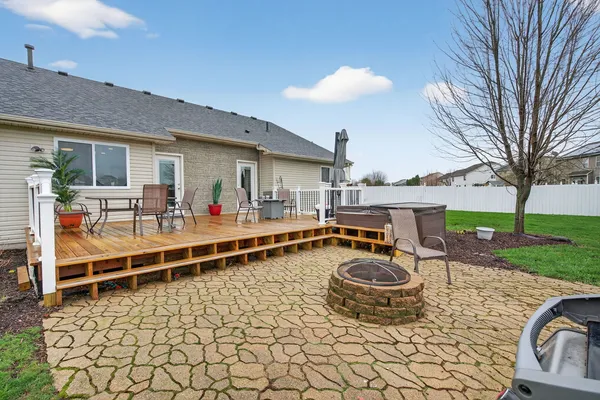 a view of a roof deck with table and chairs couches with wooden floor