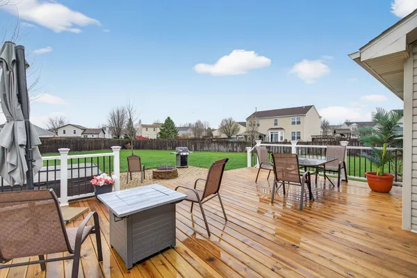 a view of a house with a big yard and sitting area