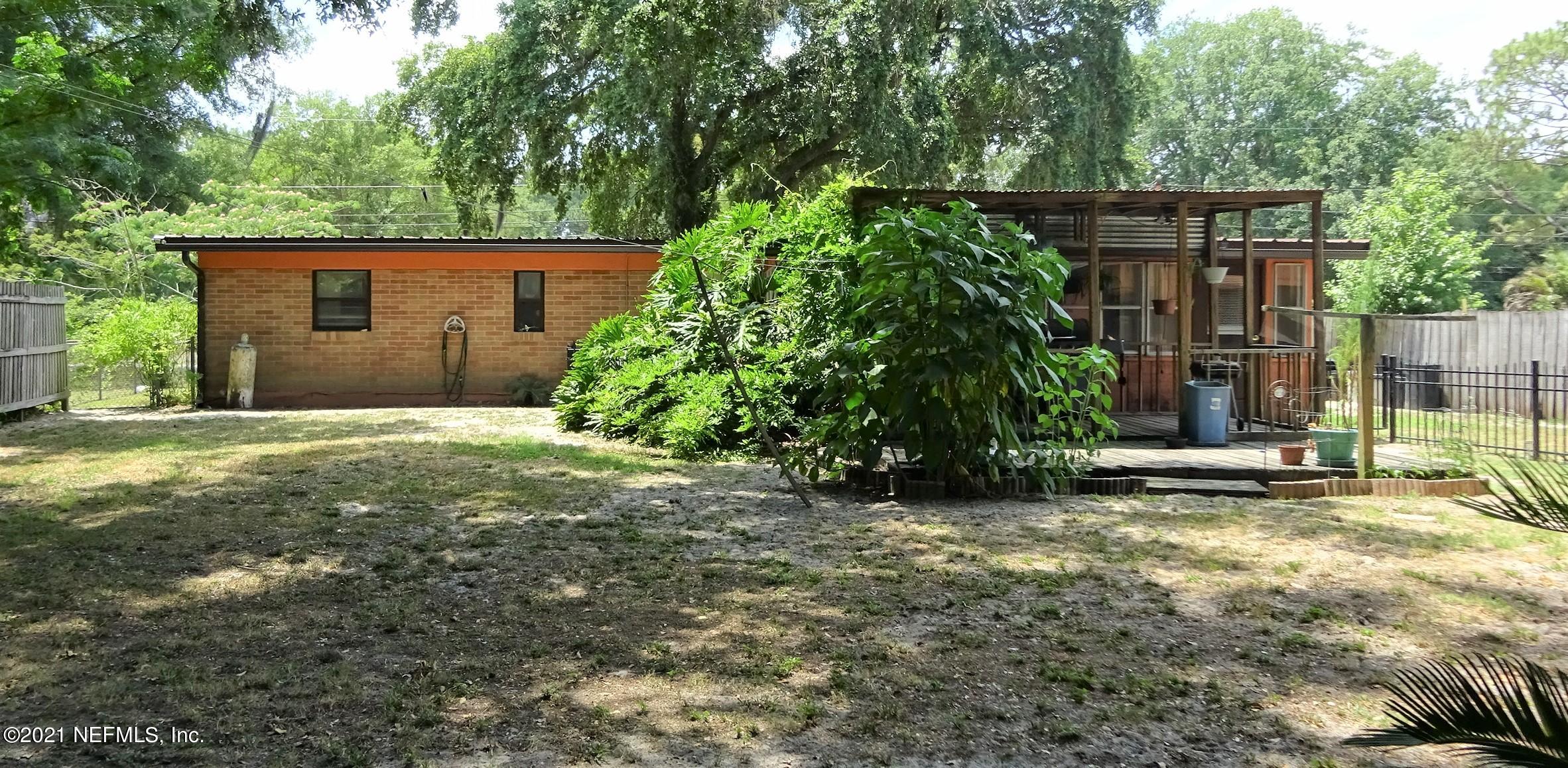 9347 Orme Road Jacksonville, FL 32220 - Photo 16 of 46 a view of a house with a small yard and large tree