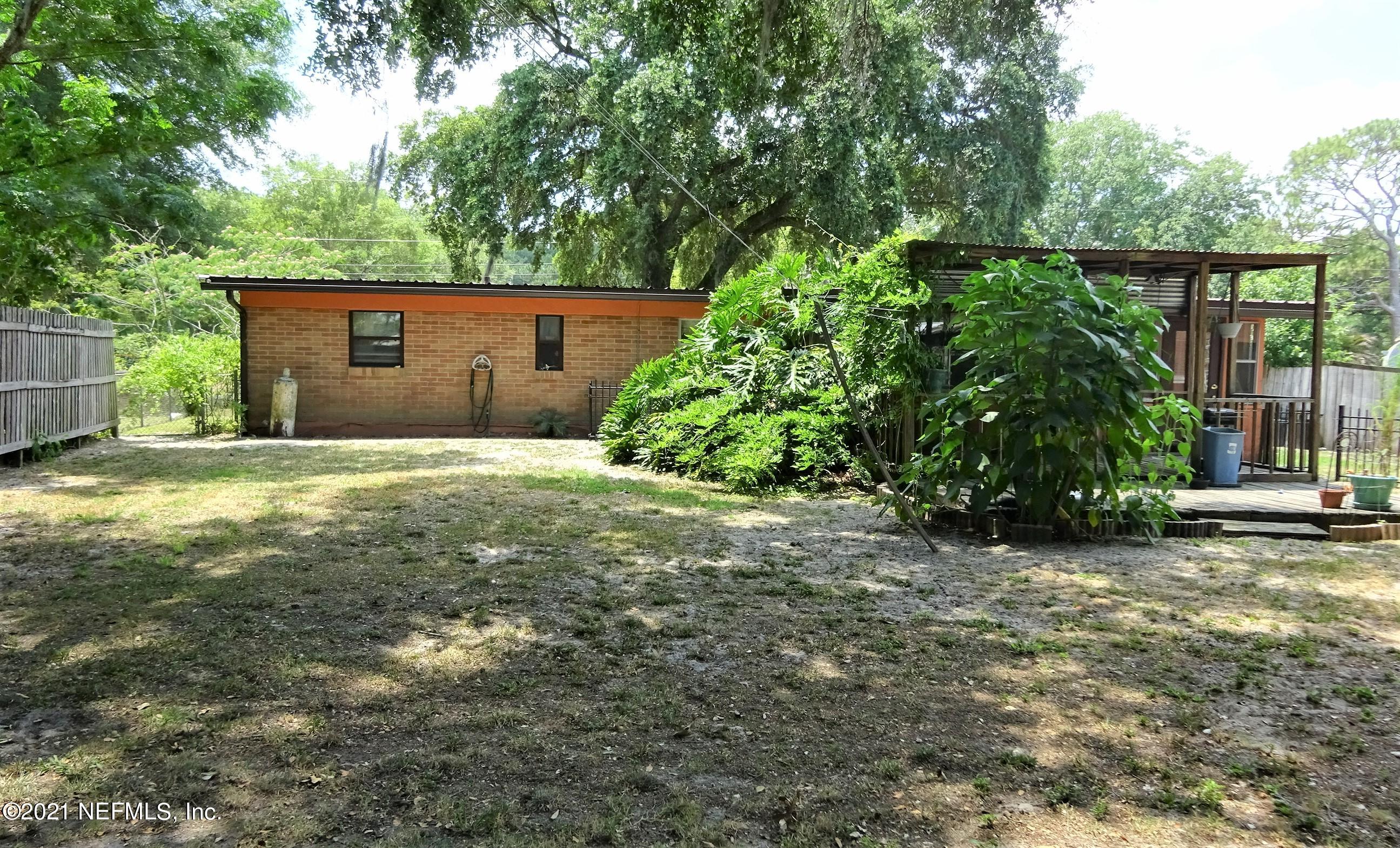 9347 Orme Road Jacksonville, FL 32220 - Photo 17 of 46 a backyard of a house with lots of green space