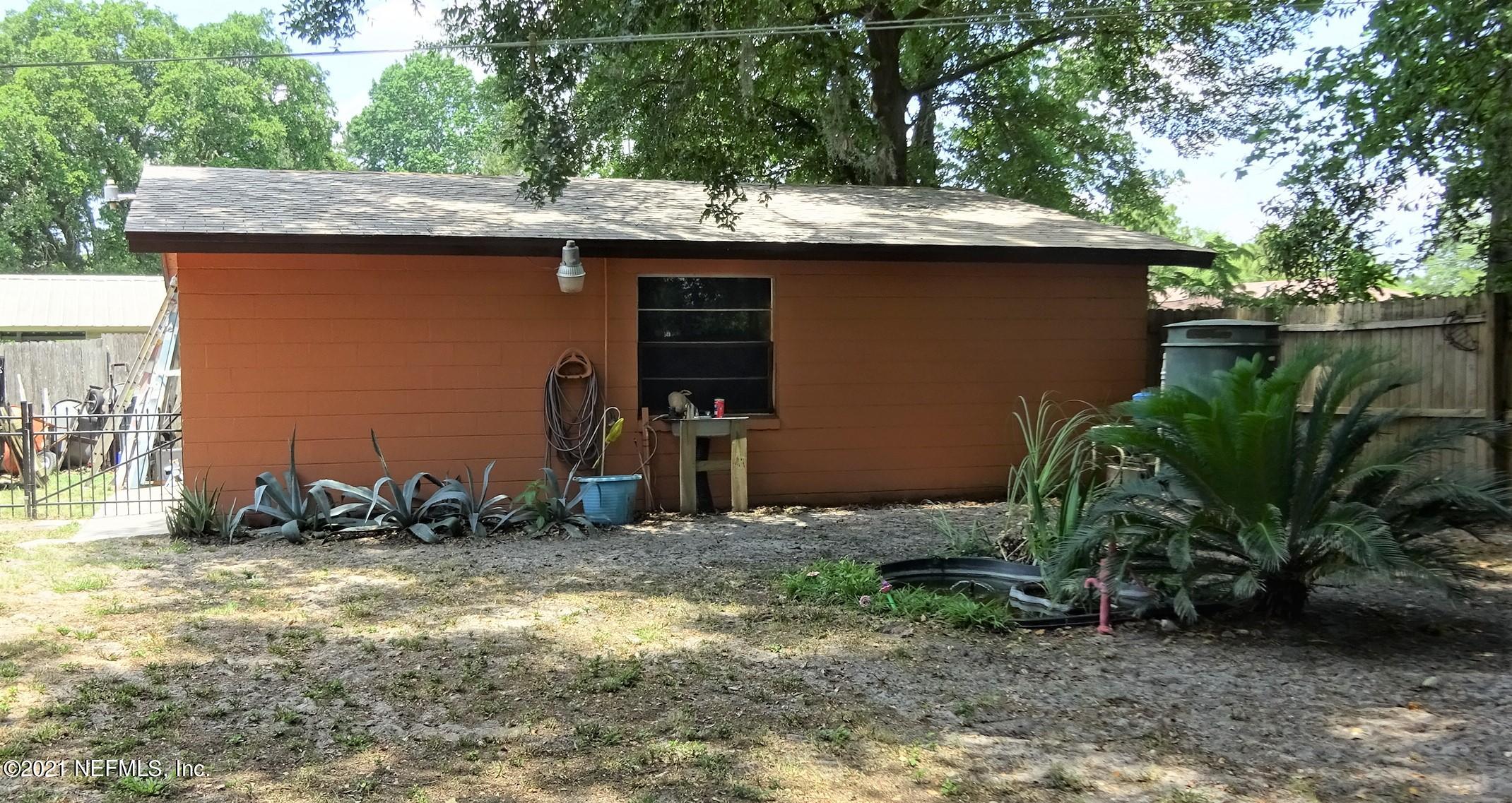 9347 Orme Road Jacksonville, FL 32220 - Photo 20 of 46 a backyard of a house with plants and tree