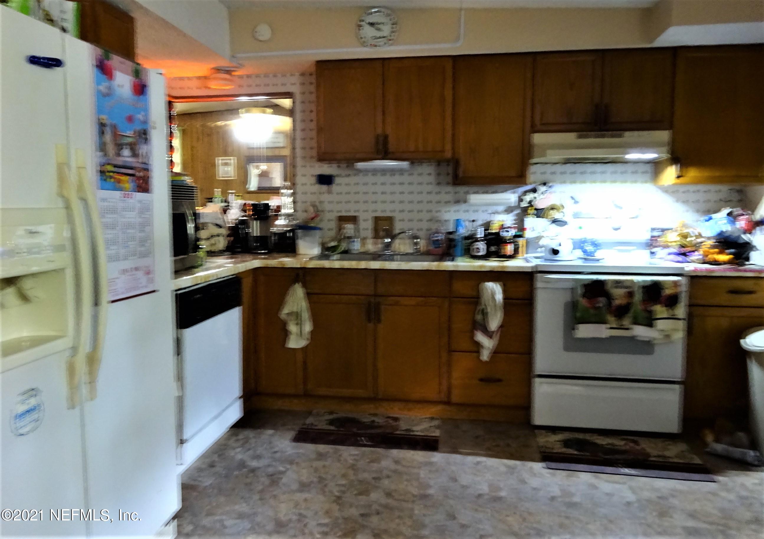 9347 Orme Road Jacksonville, FL 32220 - Photo 25 of 46 a kitchen with stainless steel appliances granite countertop a sink a stove and a refrigerator