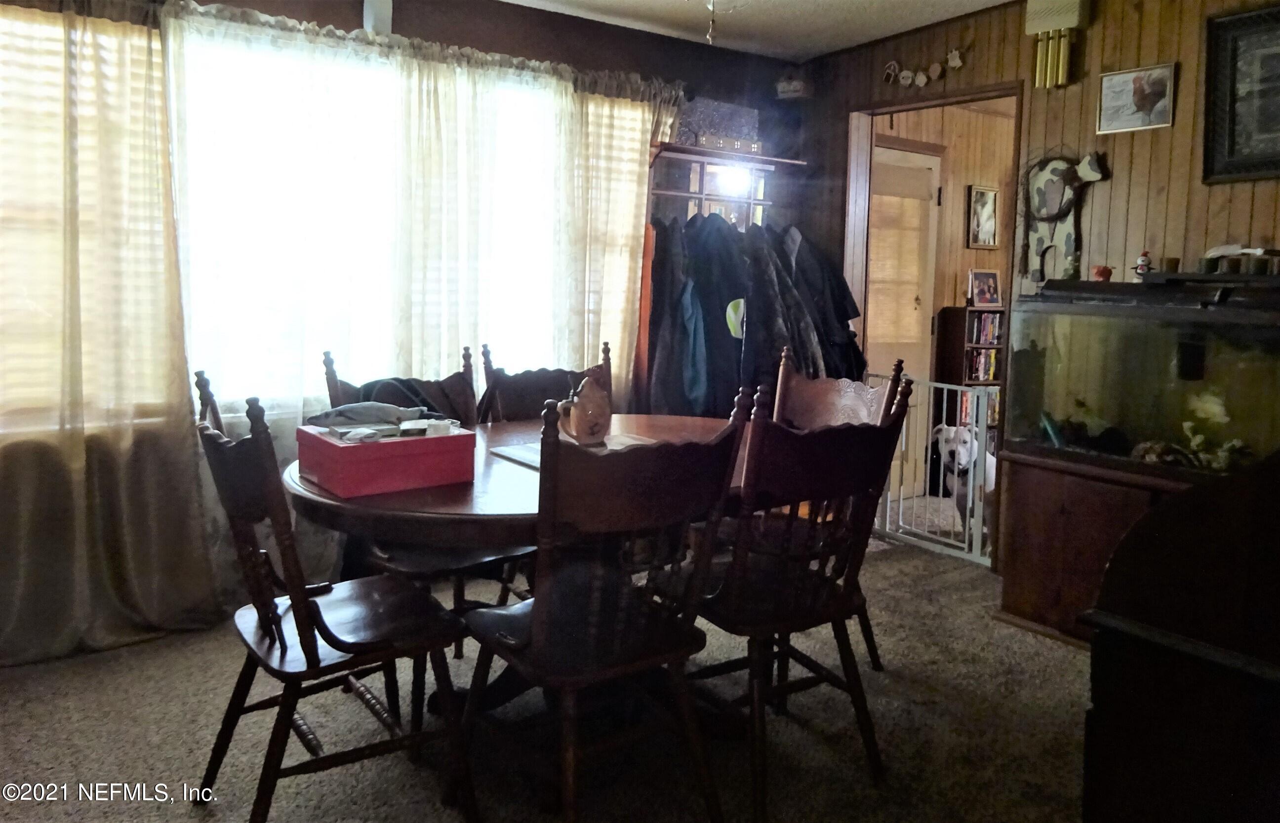 9347 Orme Road Jacksonville, FL 32220 - Photo 27 of 46 a view of a dining room with furniture and window