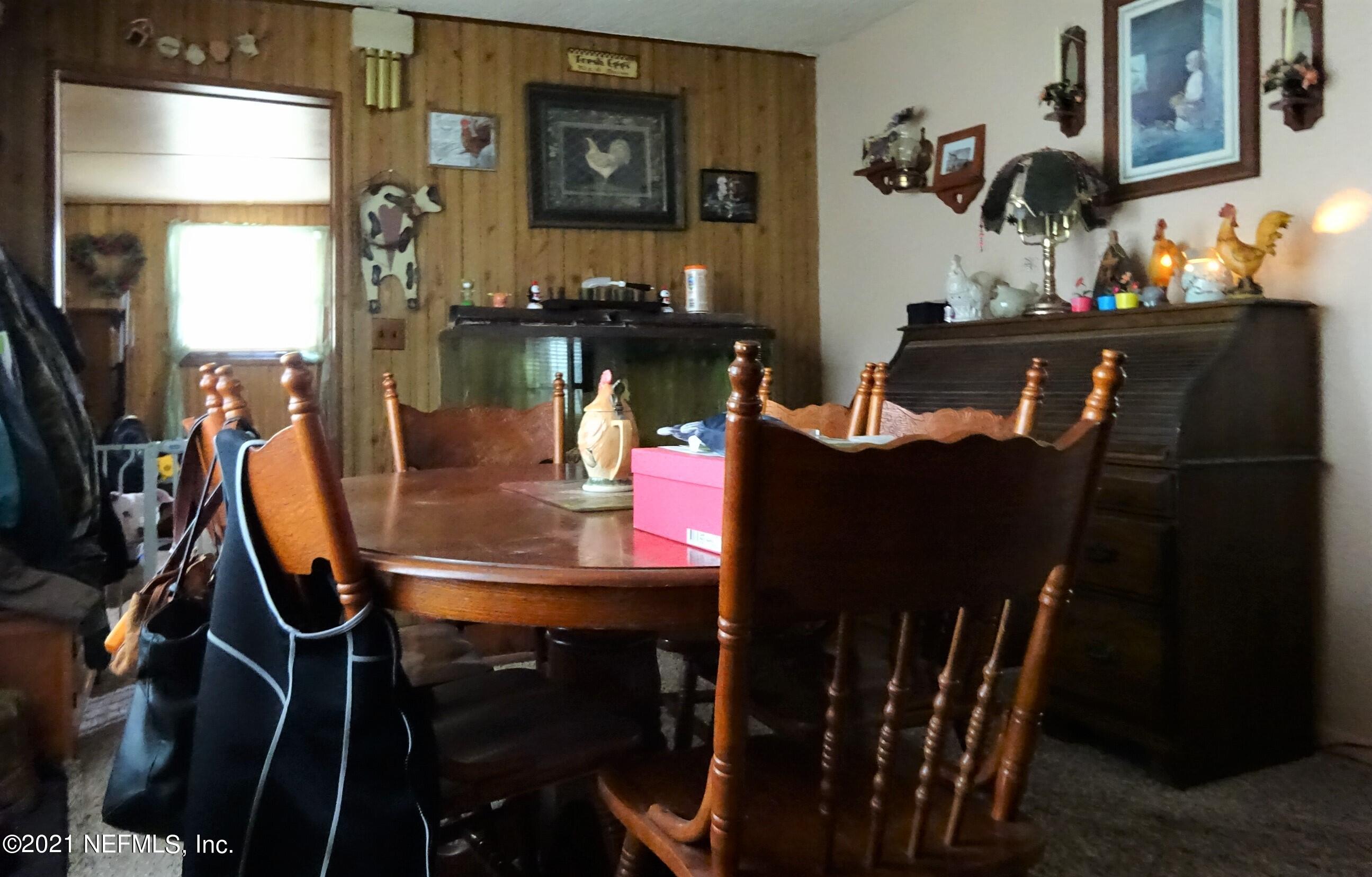 9347 Orme Road Jacksonville, FL 32220 - Photo 29 of 46 a dining room with furniture and window