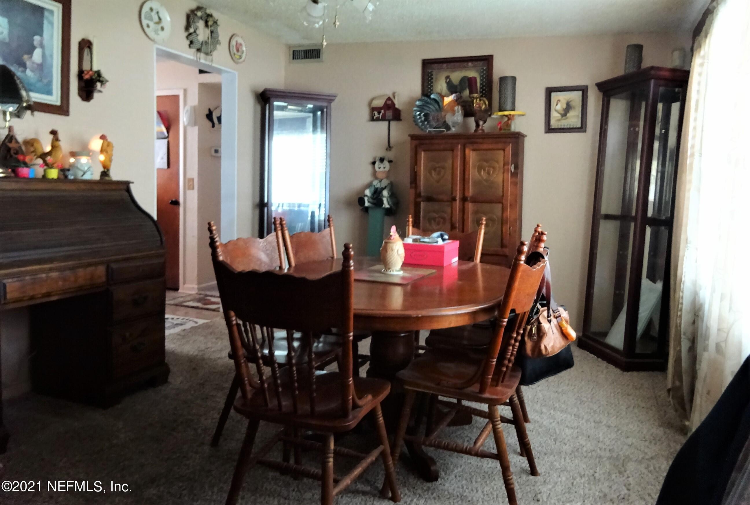9347 Orme Road Jacksonville, FL 32220 - Photo 31 of 46 a dining room with furniture and window