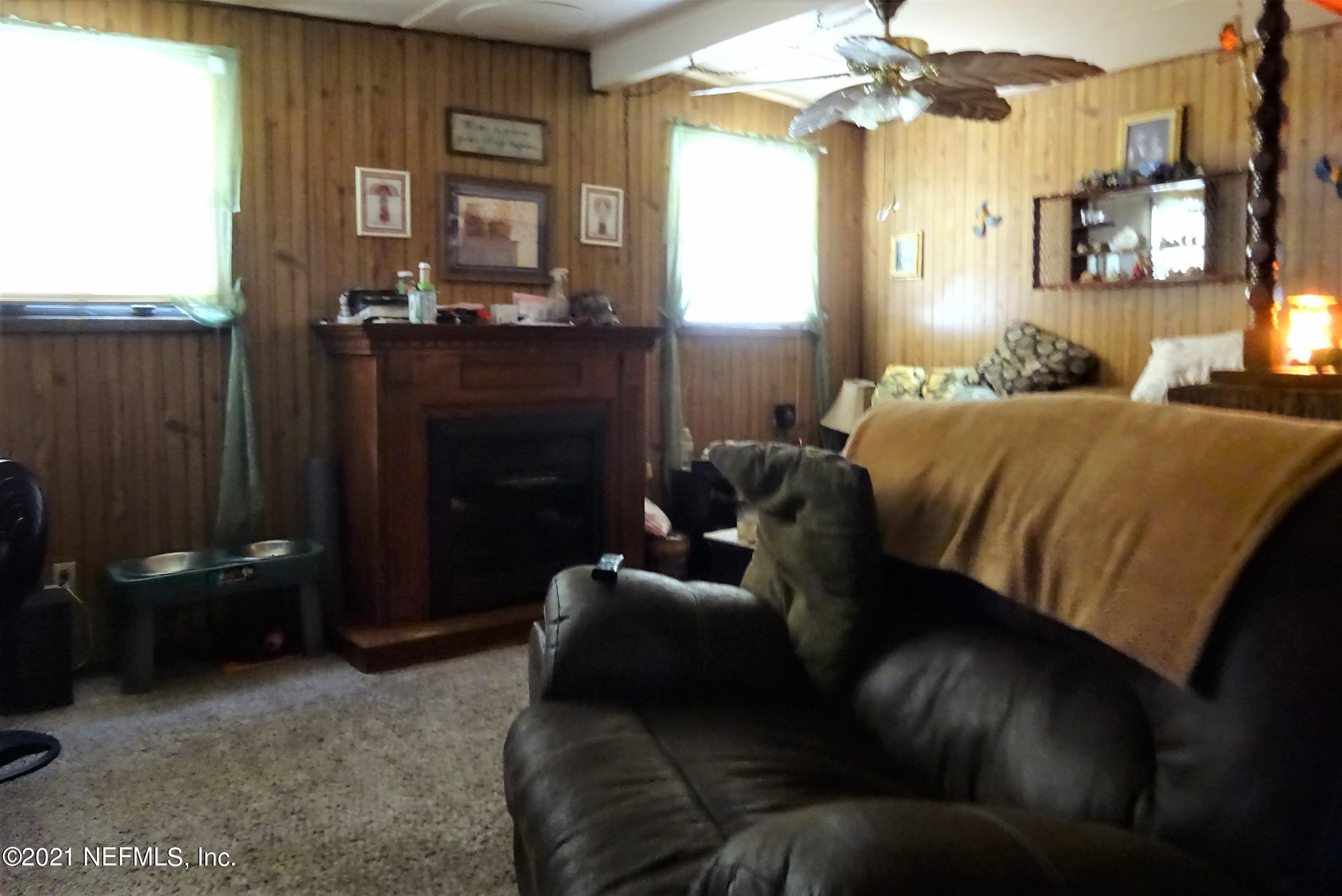 9347 Orme Road Jacksonville, FL 32220 - Photo 33 of 46 a living room with furniture and a fireplace
