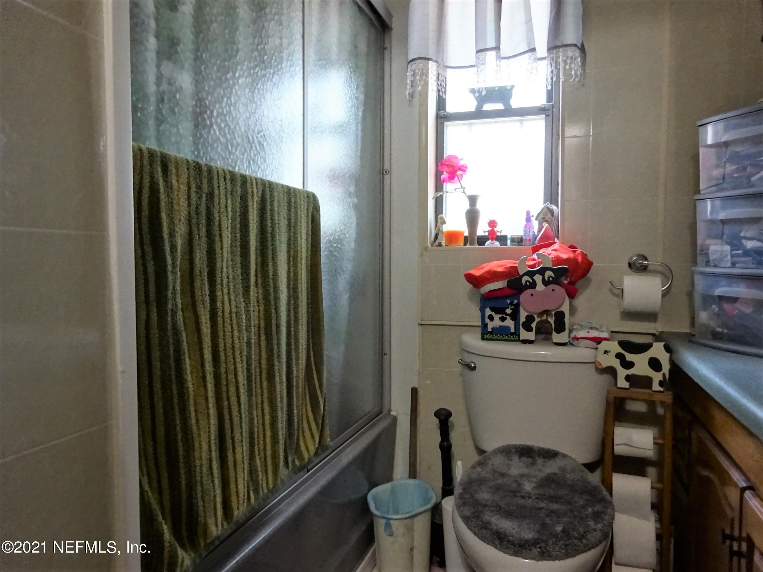 9347 Orme Road Jacksonville, FL 32220 - Photo 36 of 46 a room with a chair and a potted plant