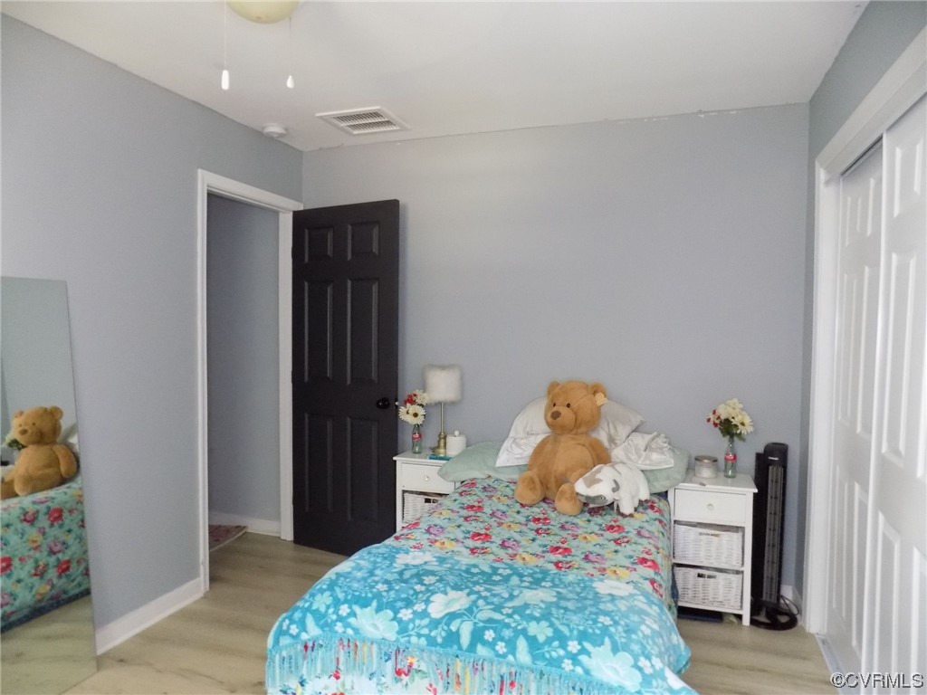 10770 Old Centralia Road Chester, VA 23831 - Photo 12 of 25 a bedroom with a bed and a dresser in it