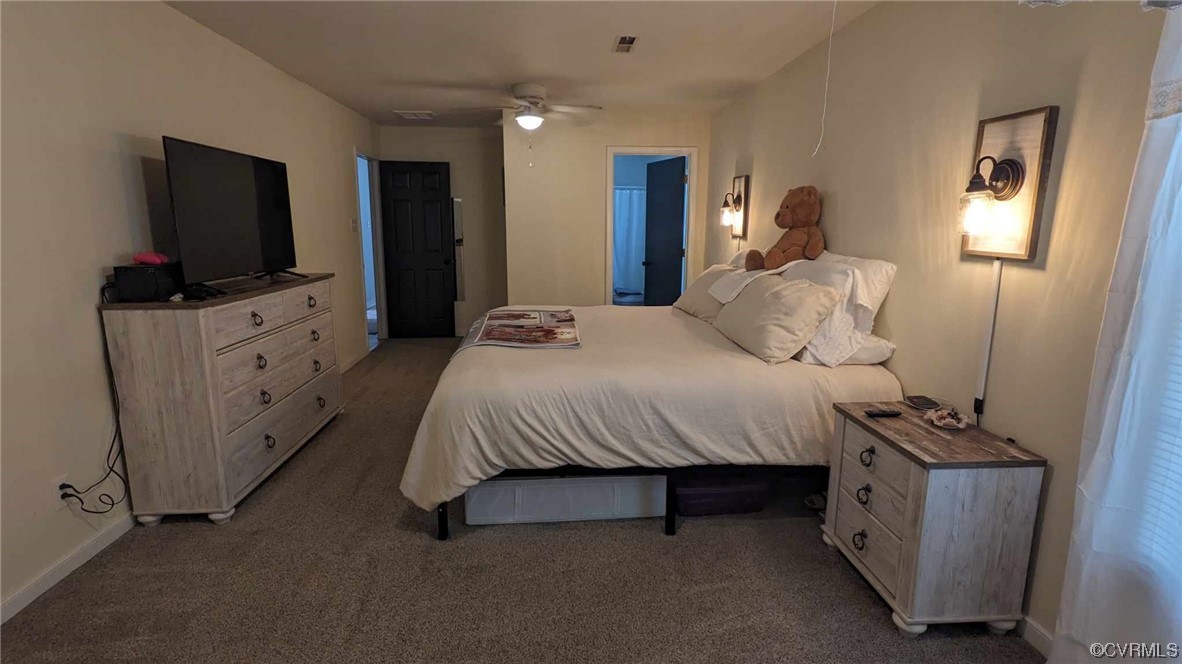 10770 Old Centralia Road Chester, VA 23831 - Photo 21 of 25 a bedroom with a bed and a flat tv screen on dresser